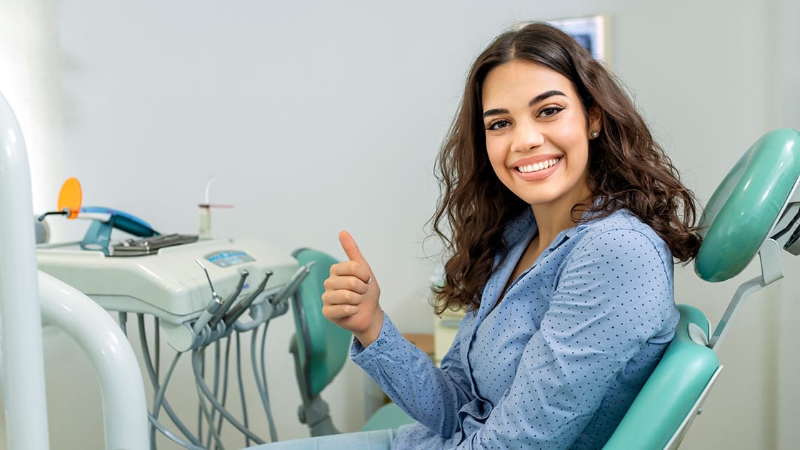 What To Expect Smiling Patient Thumbs-Up